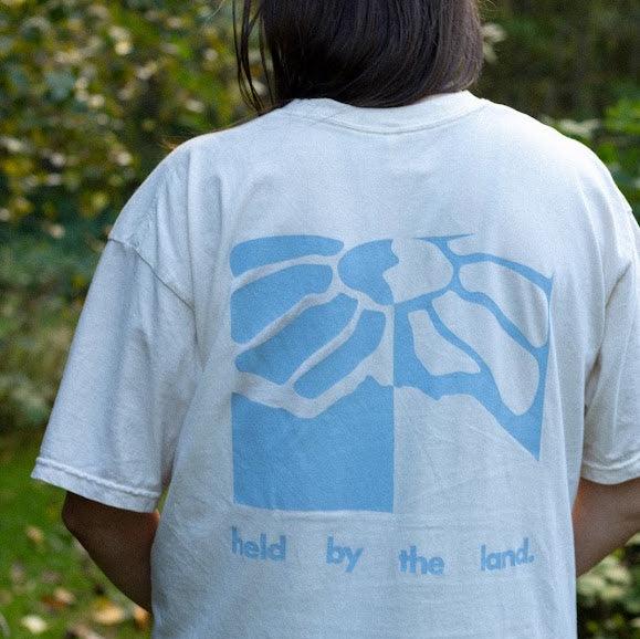 Held by the Land Tee